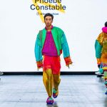 Model wearing eco and sustainable plastic walks down the catwalk at Graduate Fashion Week in colourful clothes by Phoebe Constable