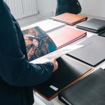 People flick through portfolios in the Norwich University of the Arts degree show