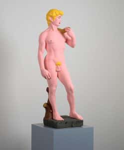 A brightly coloured nude male sculpture
