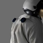 Image of a man in a spacesuit looking towards the right of the frame