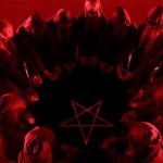 red light shining on ring of people with hooded gowns on surrounding a star