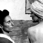 black and white image of two people looking at each other