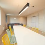 Kitchen at Duke Street Riverside showing a window, long table, multi colour chairs, light and walls