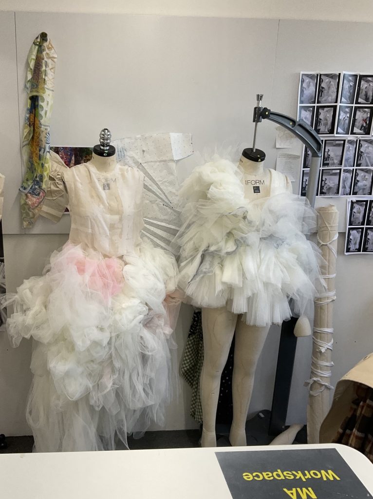 A photo of two mannequins wearing designs from Brooke Savino's MA Fashion project in the fashion studios. 
