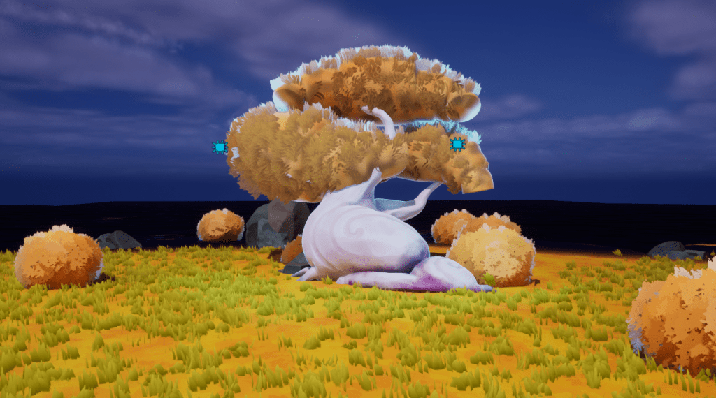 Development still from game; a large tree has thick, golden leaves and a purpleish trunk, surrounded by grasses and orange bushes. The sky behind is a deep blue with faint clouds.